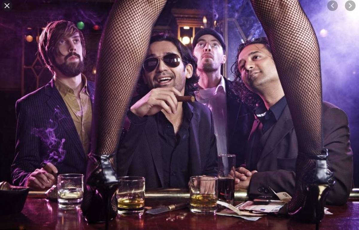 men at bar with girl in fishnet stockings